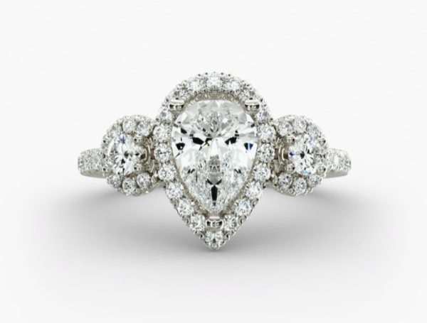 3 carat Pear solitaire, in a halo design with smaller 2 diamonds on the sides, and diamonds on the shanks Engagement Ring
