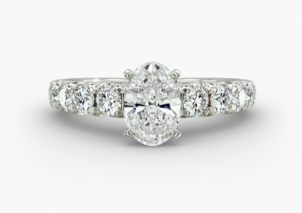 3 carat Oval shape diamond, with channel set smaller diamonds Engagement ring